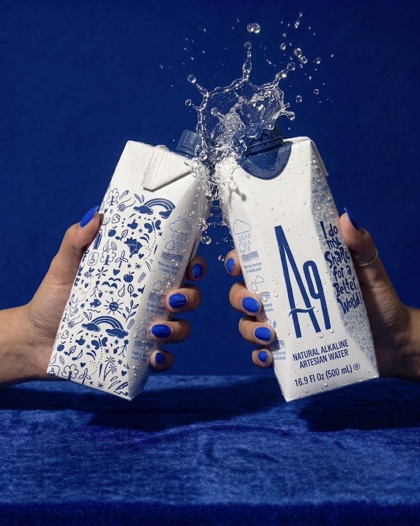 Two A9 water cartons raised together with a splash of water